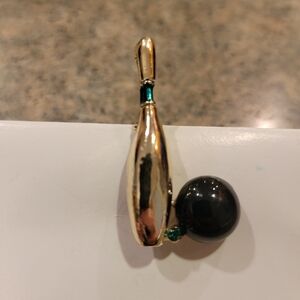 VINTAGE Gerrys bowling pin and ball brooch. Gold with green rhinestone